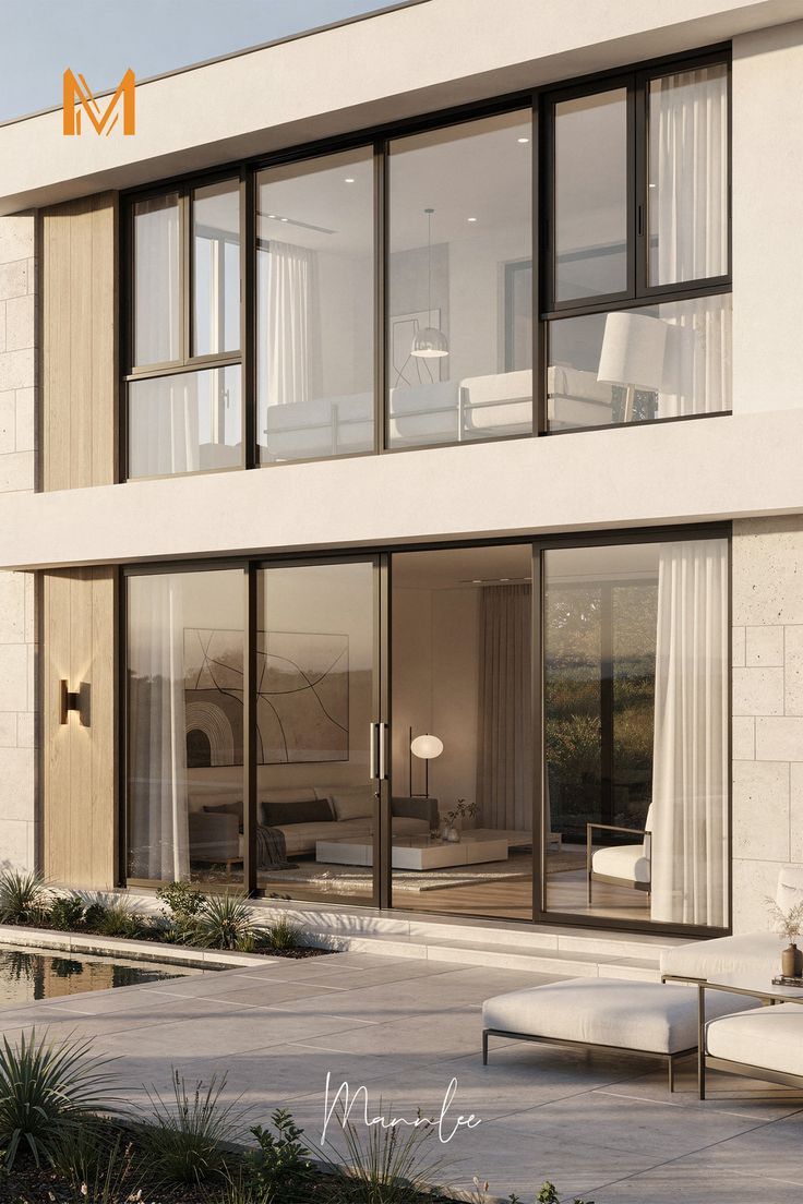 Contemporary home with full-height dark-framed glazed doors and upper-storey aluminium windows
